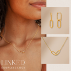A woman wears the Linked Necklace & Earrings Set, featuring interlocking gold links; shown close up, this elegant set makes a perfect anniversary gift.