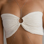 A person wears a textured white bandeau top with a center ring, paired with the Sprinkle Diamond Body Chain in Sterling Silver and delicate silver jewelry for elegant, layered styling.