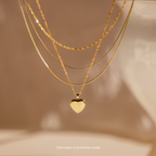 Mystery Jewelry features three layered gold necklaces, including one with a heart-shaped pendant, displayed on a neutral background to add whimsical charm to your collection.