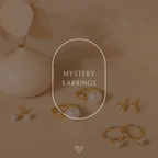 Mystery Earrings from our collection are showcased beside a cream vase, with "Mystery Earrings" featured at the center.