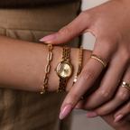 Close up of a model showcasing a stylized look with our Cobblestone Timepiece watch, cube bracelet and pave linked bracelet.