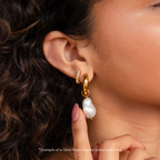 Close-up of a woman's ear wearing a gold hoop and pearl earring—an elegant look you could receive in your next Monthly Earrings Subscription Box.