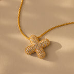 Showcased on a beige background, the Pave Puff Letter Necklace in 18K Gold features a textured, diamond-studded letter pendant with sparkling pave diamonds.