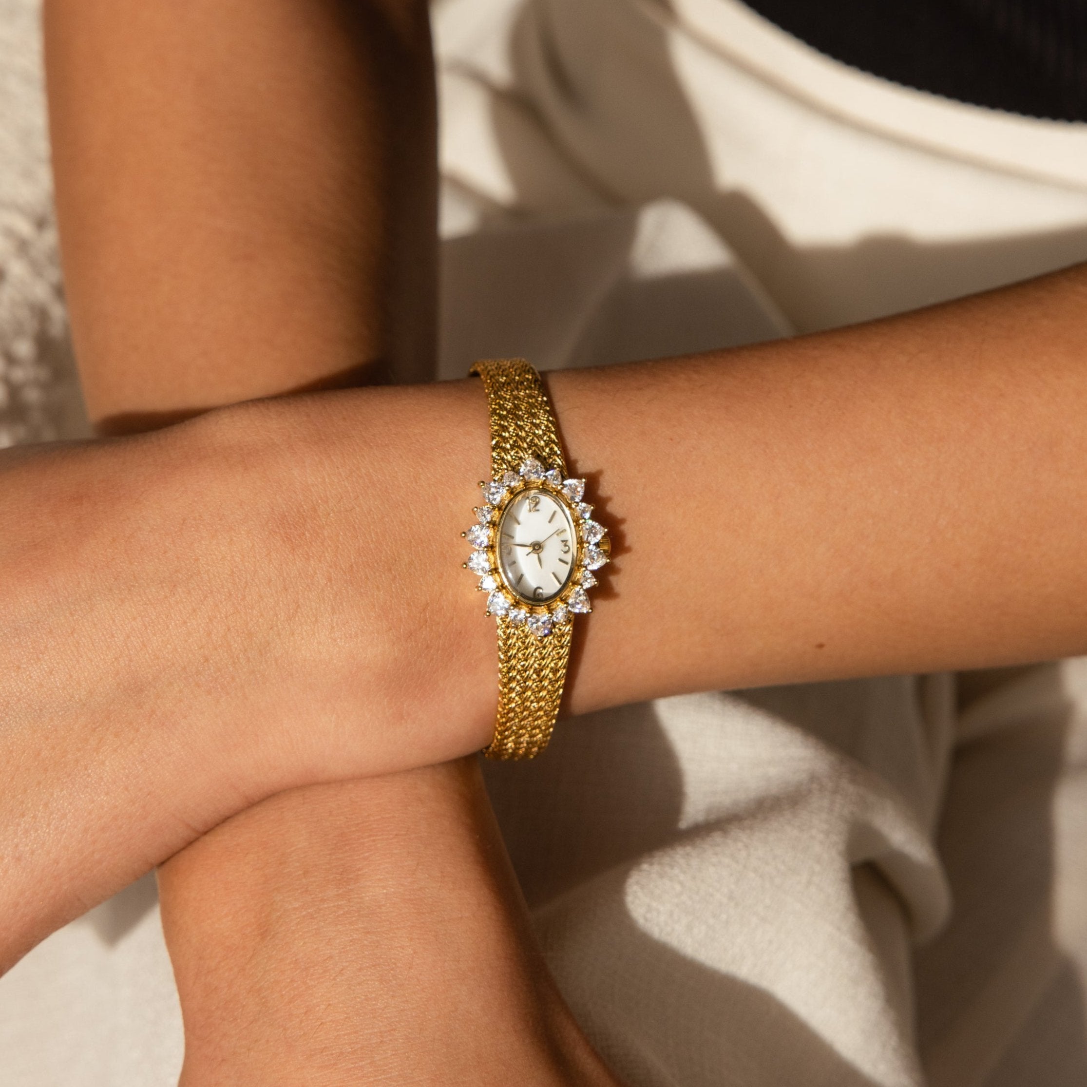 The Pave Heart Timepiece graces the wrist with heart-shaped gemstones, adding a unique sparkle to its elegant, jeweled face and refined design.