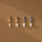 Four pairs of Aquamarine Pearl Drop Earrings—two gold, two silver—capture vintage glamour with pearls on a brown background. Timeless and elegant, perfect as wedding earrings.