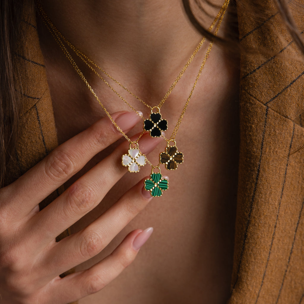 Gemstone Clover Necklace set with black onyx, white mother of pearl, green malachite, and brown tiger’s eye on delicate 18K.