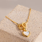 Hinged Circle Charm Bracelet in 18K Gold displayed on a textured stone block—a perfect accessory for lovers of minimalist jewelry.