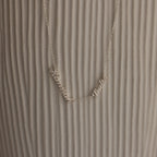 Carrie Multiple Name Necklace with Hanna and Pablo on a textured, light background—a perfect personalized jewelry piece.