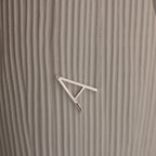 Large Sideways Initial Necklace in Sterling Silver showcased on a textured beige background.