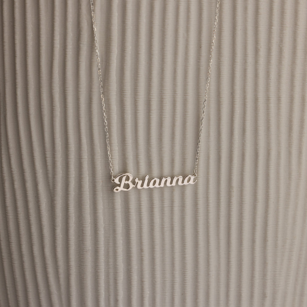 Mellow Name Necklace with "Brianna" shown on a textured, light background—a stylish personalized necklace for any occasion.