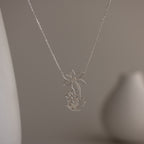 Sterling silver necklace featuring your child's drawing as a unique pendant, displayed on a soft, neutral background—perfect as wearable art or a personalized gift for someone special.