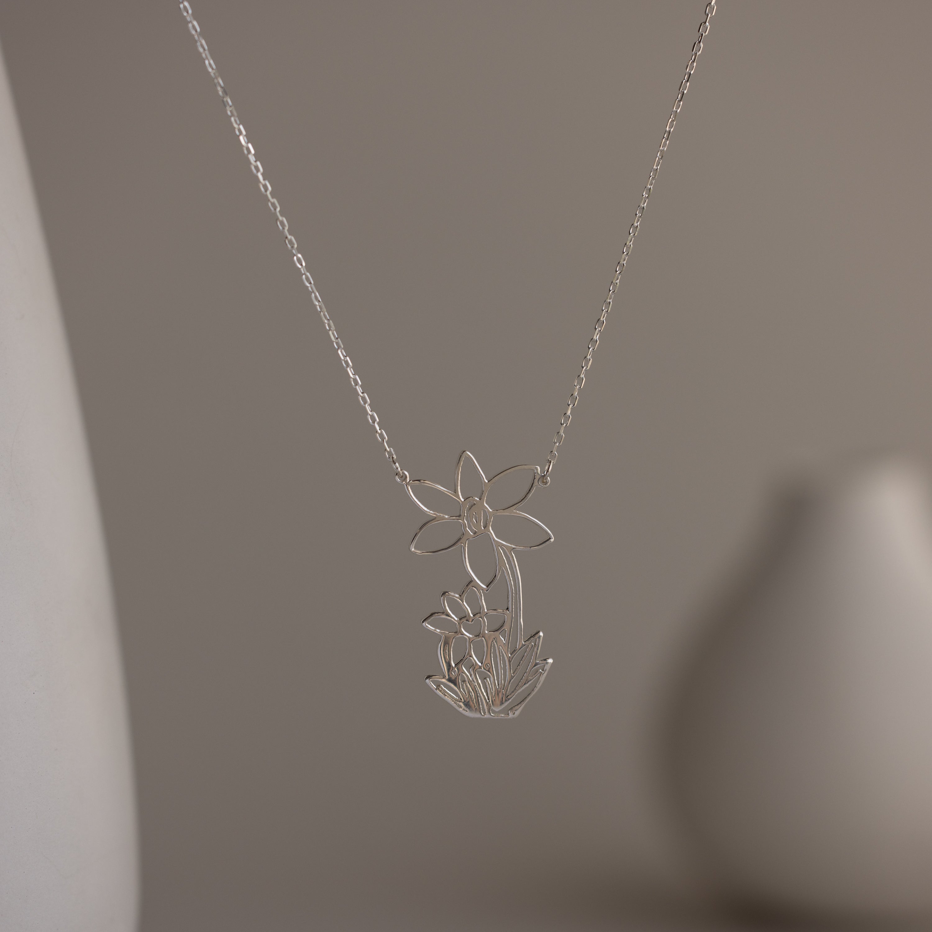 Sterling silver necklace featuring your child's drawing as a unique pendant, displayed on a soft, neutral background—perfect as wearable art or a personalized gift for someone special.