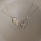 The Custom Fingerprint Necklace in Sterling Silver set features two oval pendants engraved with detailed fingerprints, making a stunning example of personalized jewelry displayed side by side.