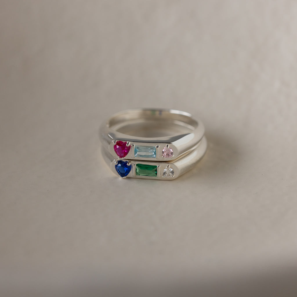 The Bold Birthstone Signet Ring in Sterling Silver shines with colorful gemstones—red, blue, green, or clear—making it the ideal customizable jewelry piece or unique stackable birthstone ring set.