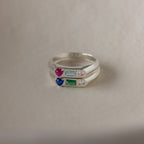 The Bold Birthstone Signet Ring in Sterling Silver shines with colorful gemstones—red, blue, green, or clear—making it the ideal customizable jewelry piece or unique stackable birthstone ring set.