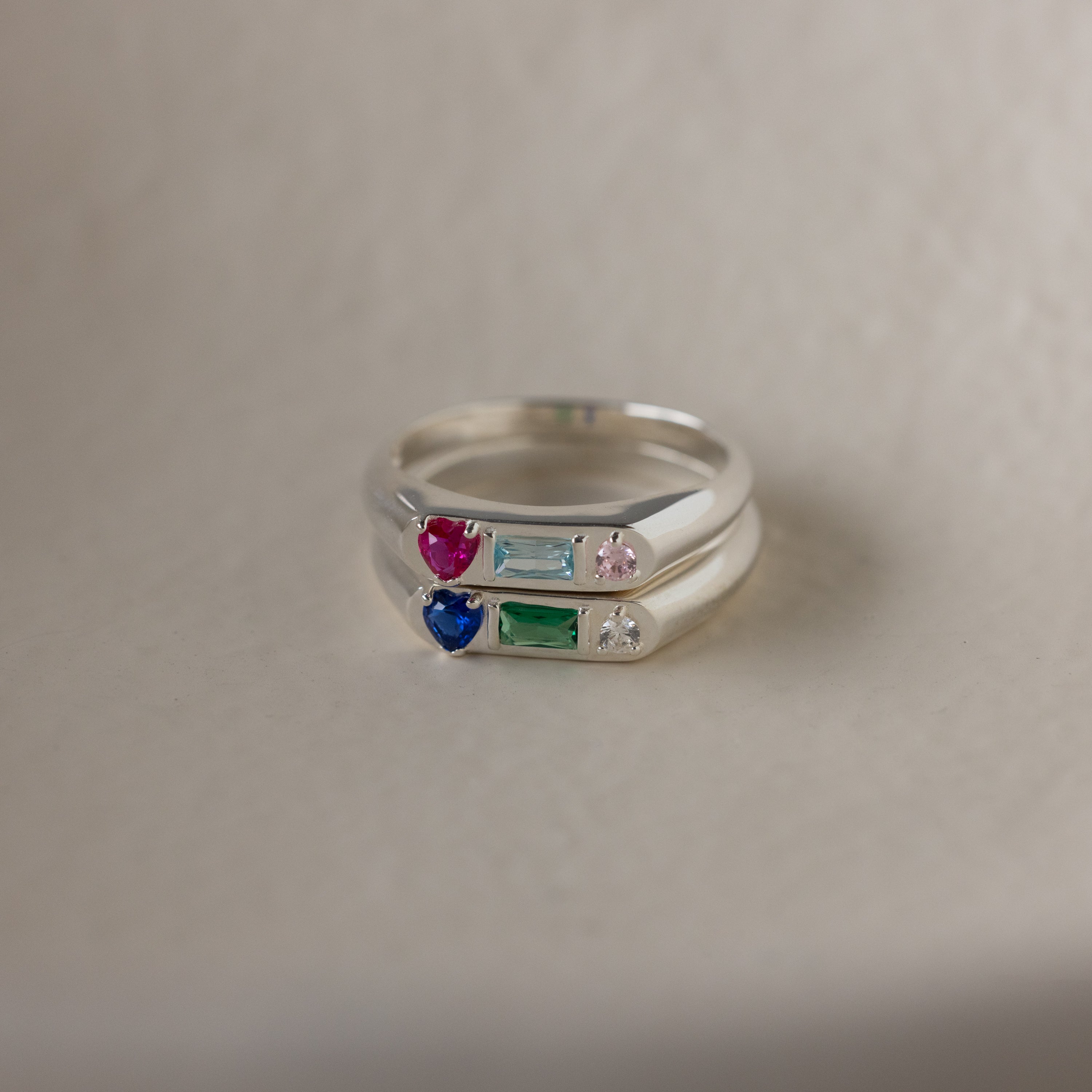The Bold Birthstone Signet Ring in Sterling Silver shines with colorful gemstones—red, blue, green, or clear—making it the ideal customizable jewelry piece or unique stackable birthstone ring set.