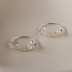 Two Grace Script Name Rings in Sterling Silver, each personalized with an elegant script font—one engraved with "Amelia," the other with "Aurora.