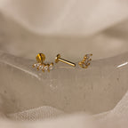 Marquise Diamond Climbers in 18K Gold, featuring elegant diamond studs, perfect for wedding jewelry, displayed on a textured, translucent surface.