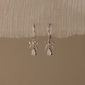 Flatlay of our Teardrop Ribbon Charm Hoops in Silver