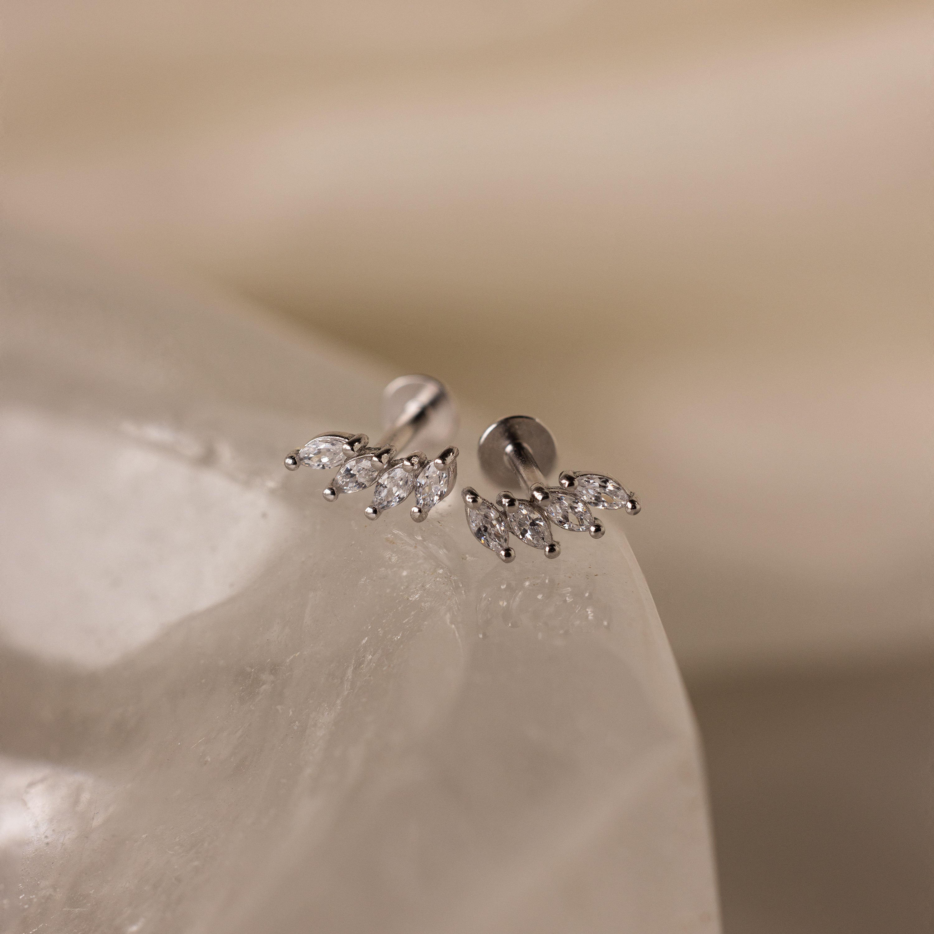 Close-up of Marquise Diamond Climbers in Silver, featuring small marquise-shaped crystals on a smooth white stone—an elegant choice for wedding jewelry.