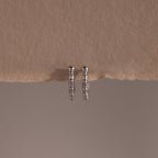 Beaded Hoops in Sterling Silver feature a beaded design that adds texture and shine, beautifully showcased against a beige textured background.