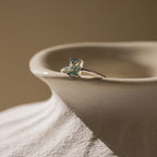 Agate Emerald Ring in silver resting on a vase