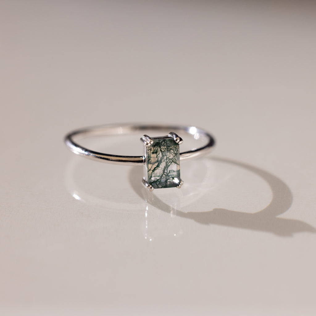 Silver Agate Emerald Ring resting on a flat surface