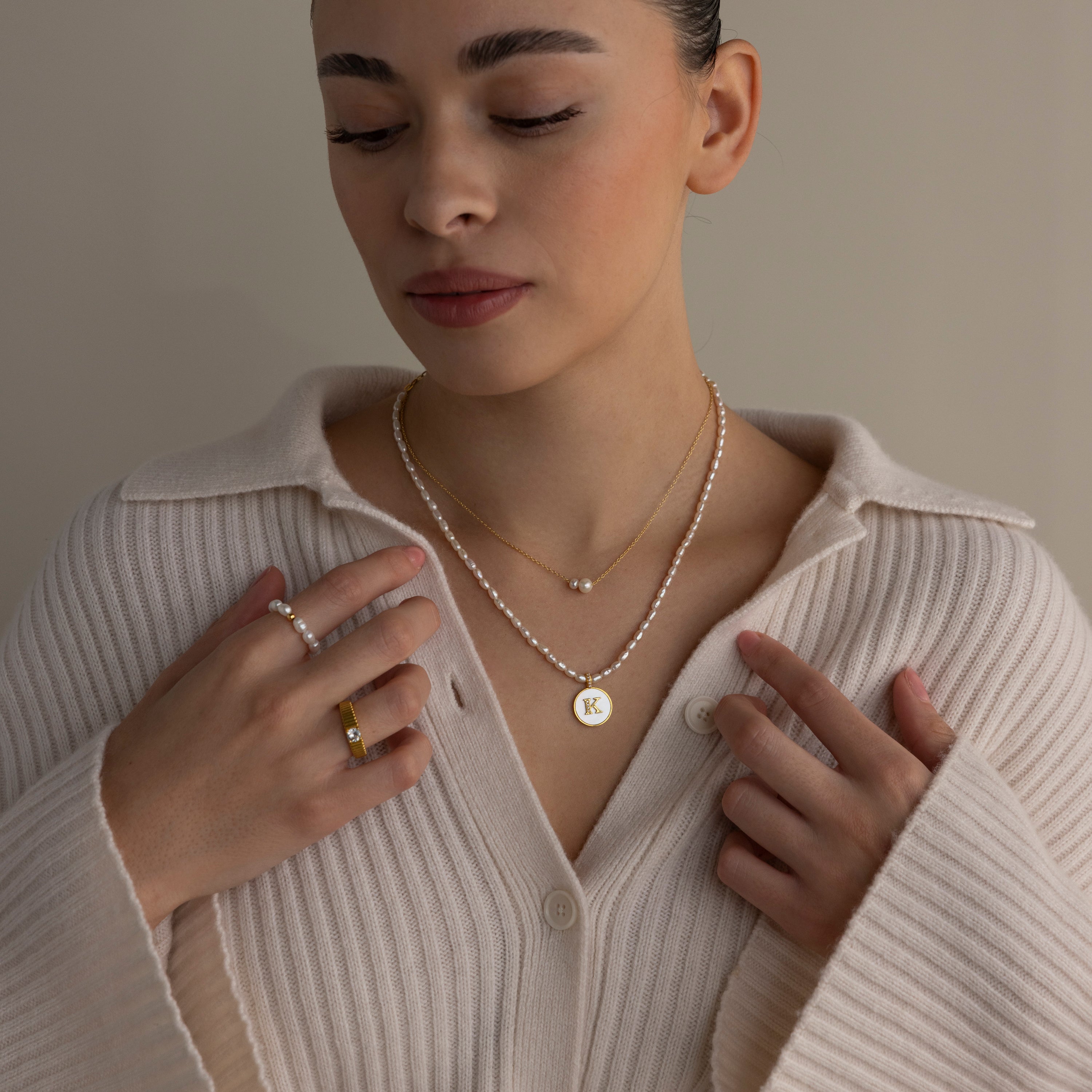Woman wearing a cream sweater and the Dainty Duo Pearl Necklace in 18K Gold—an elegant gift for loved ones or as timeless wedding jewelry.