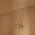 Diamond Bow Charm in Sterling Silver, adorned with CZ diamonds and set against a shimmering gold backdrop—a coquette-inspired accessory that sparkles with elegant charm.