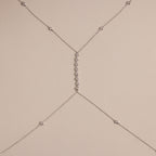 Detailed shot of the silver version of the body chain against a neutral background, featuring the fine chainwork and diamond details.