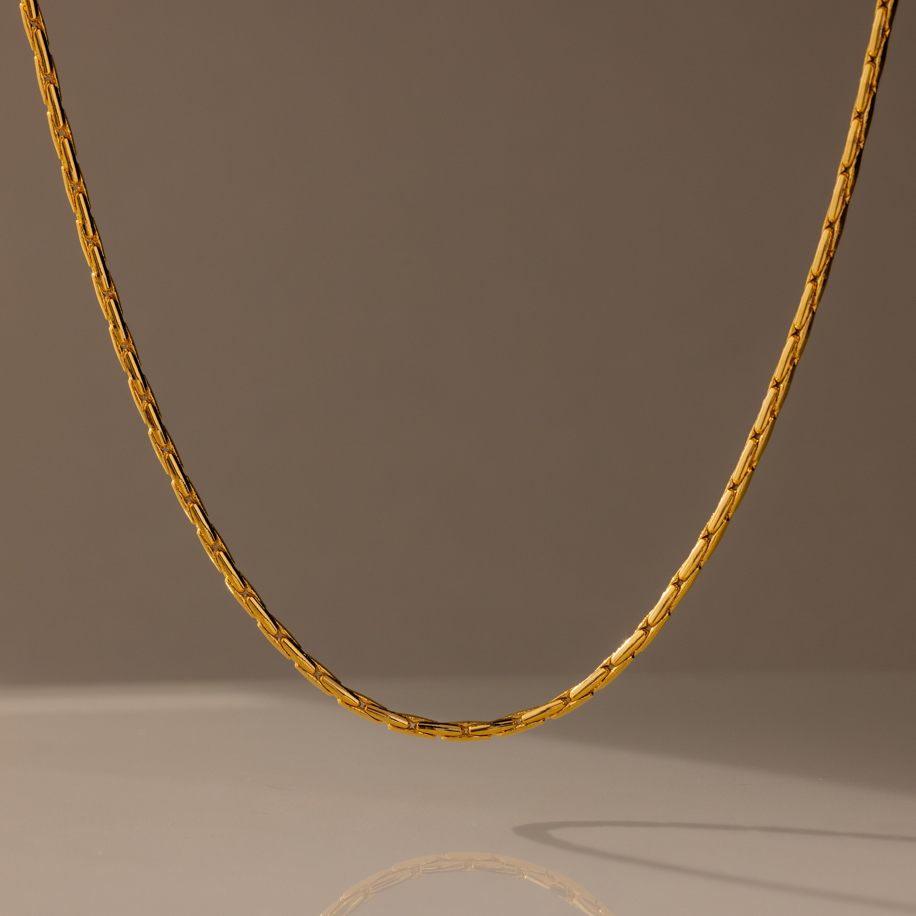 The Bold Link Chain Necklace in 18K Gold is displayed against a neutral, softly lit background.