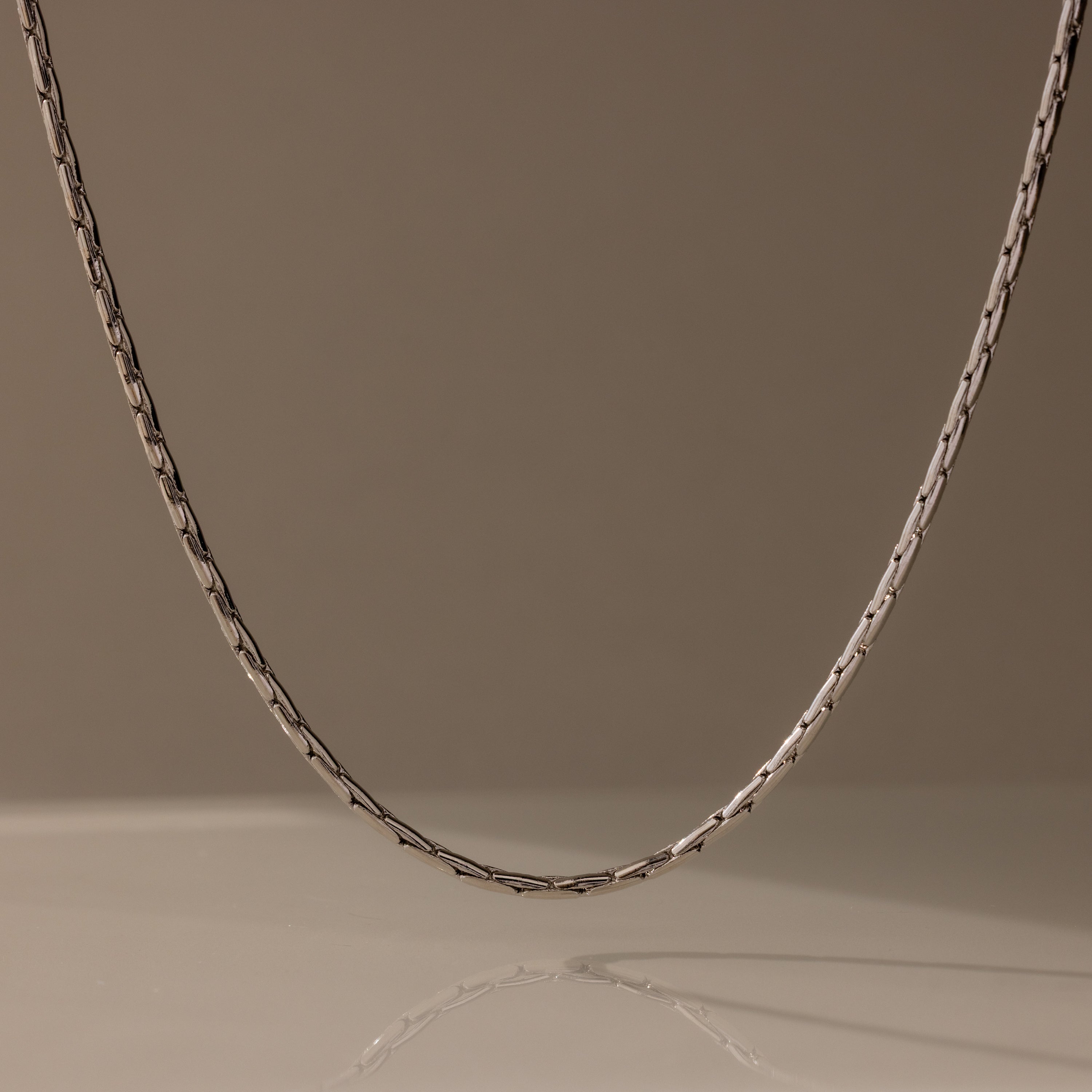 The Bold Link Chain Necklace in Silver stands out against a plain, neutral background.