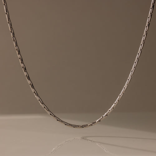 The Bold Link Chain Necklace in Silver stands out against a plain, neutral background.