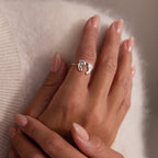 A manicured hand wears the Hand & Footprint Duo Name Ring in Sterling Silver on the index finger—a charming keepsake gift ideal for new parents.