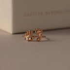 The Hand & Footprint Duo Name Ring in Rose Gold features delicate hand and foot shapes, engraved with a name for a personalized touch—an ideal keepsake jewelry gift for new parents.