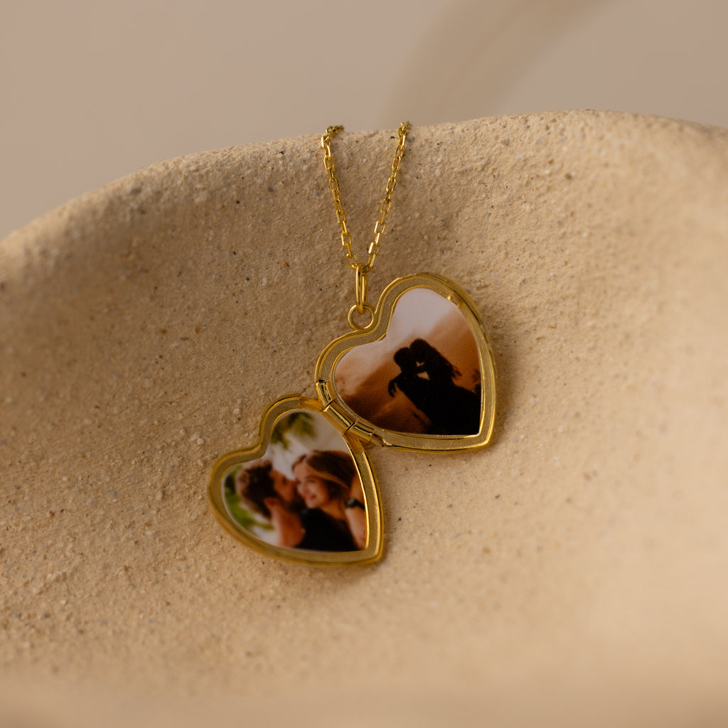 Close up flatlay image of the inside of our Engraved Heart Locket Necklace in 18K Gold