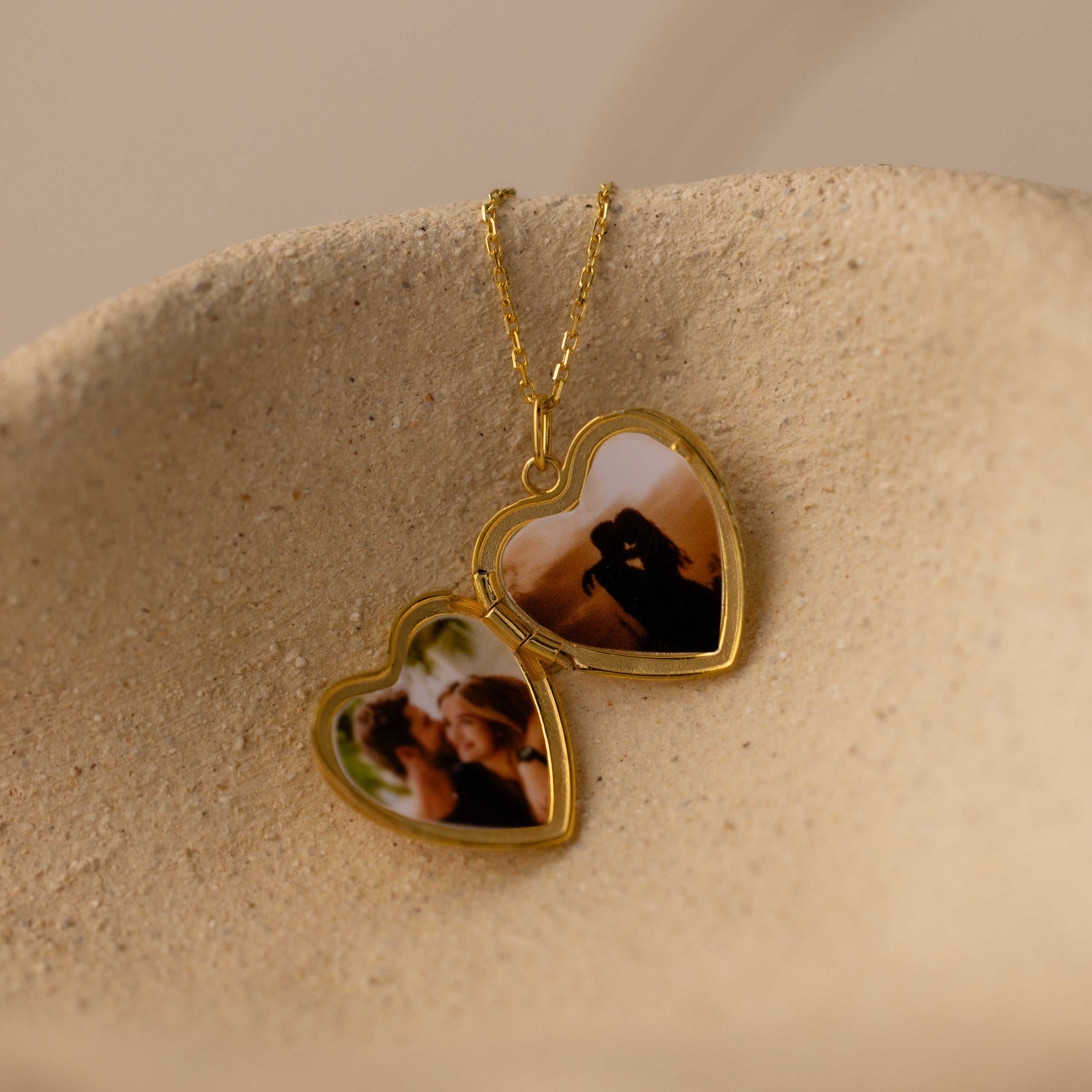 Close up flatlay image of the inside of our Engraved Heart Locket Necklace in 18K Gold