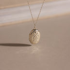 The Floral Handwriting Locket Necklace in Sterling Silver features delicate engraving on a fine chain—a timeless keepsake for treasured memories.