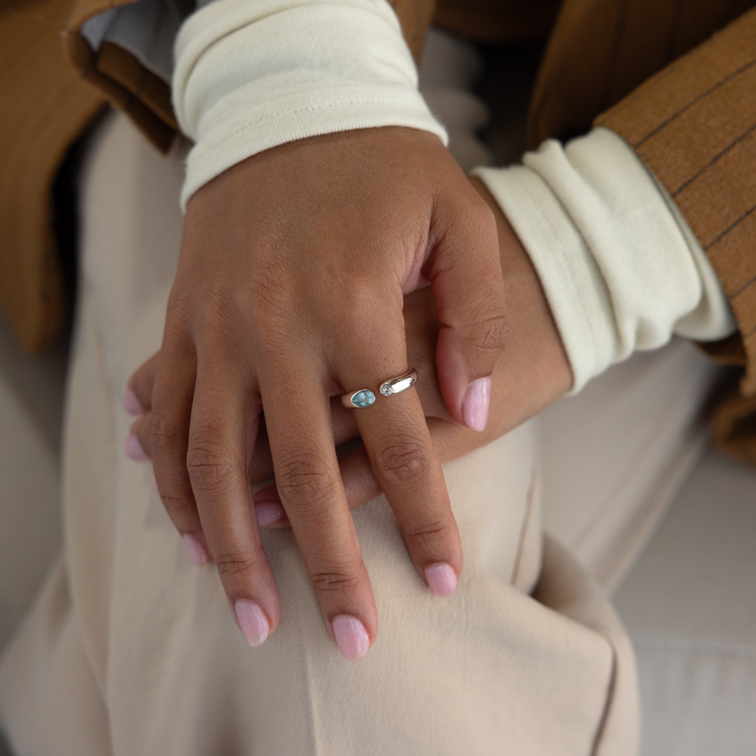 Close-up of hands with light pink nails wearing the Toi et Moi Birthstone Signet Ring, featuring a custom turquoise gemstone on the middle finger.