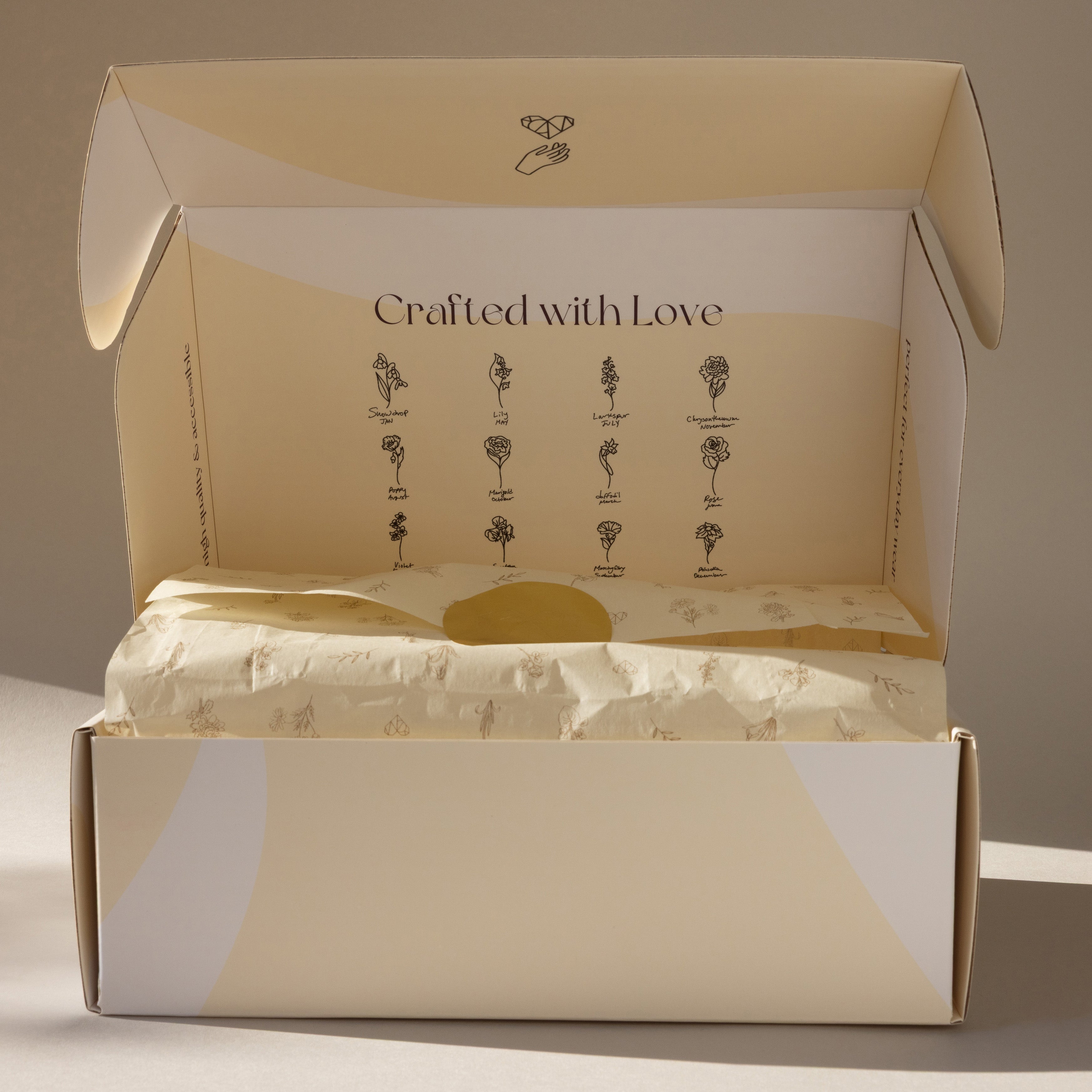 The Gift Box Add-On features an open beige box with "Crafted with Love" text and floral illustrations inside the lid—a perfect elegant finishing touch for your gift wrapping.