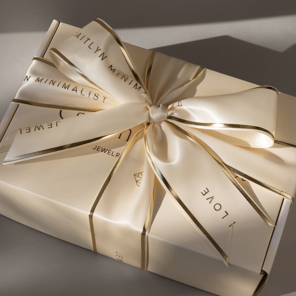 The Gift Box Add-On features a cream-colored box with elegant wrapping, a matching ribbon edged in gold, and printed words for an extra-special finishing touch.