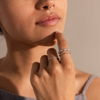 A woman wearing a nose ring touches her chin, displaying the Pave Opal Ring Set in Sterling Silver and highlighting its elegant, timeless design on her hand and fingers.