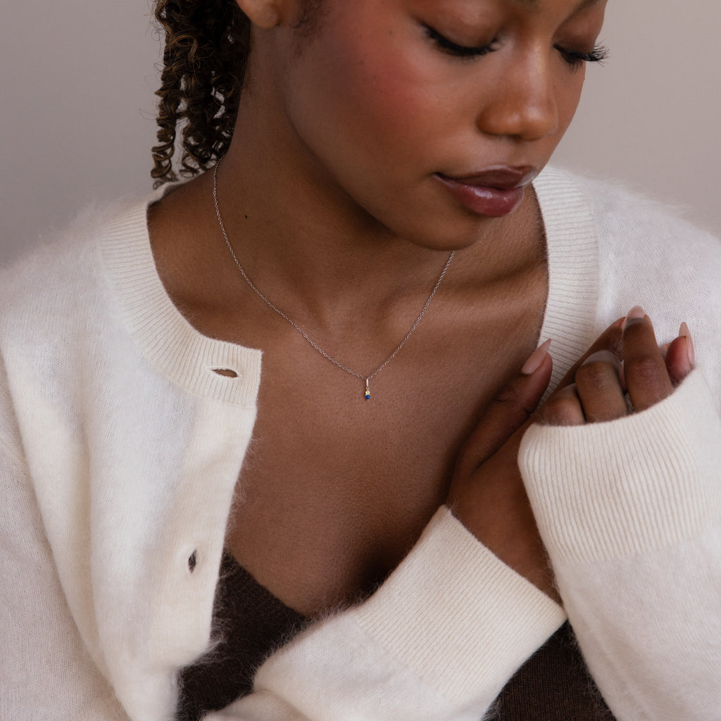 Model poses while wearing silver cable chain with Dainty Duo Birthstone Charm