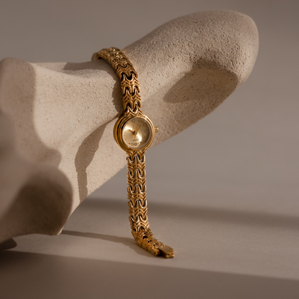 Uur Wavy Link Timepiece watch on a stone surface with a neutral background