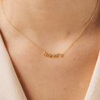 The Mrs. Necklace features elegant gold cursive lettering, designed to be worn around the neck—an ideal and chic wedding gift for any bride-to-be.