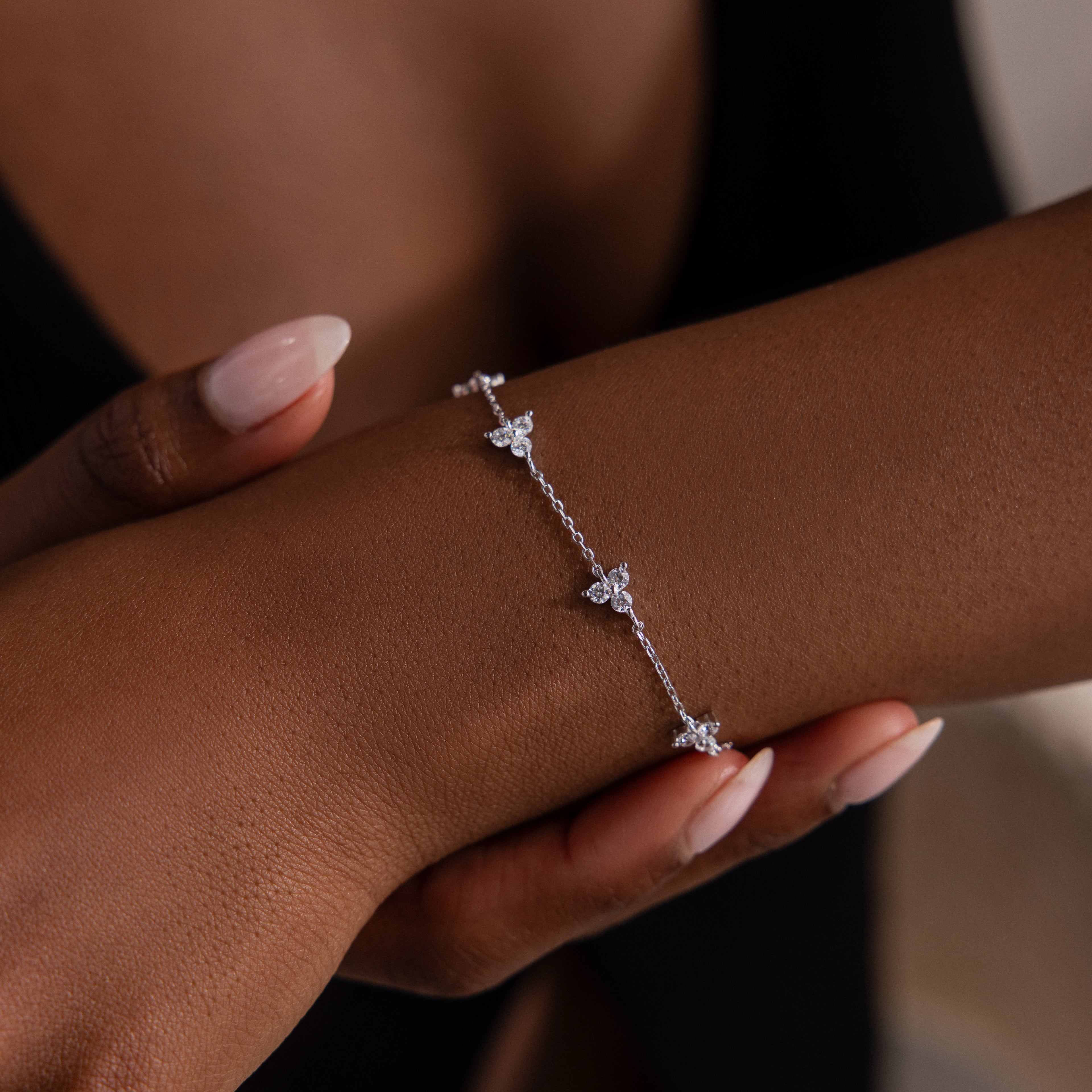Silver bracelet on a wrist with a blurred background
