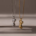 The Kinn Body Necklace features two abstract female torso shaped pendants—one silver, one gold—making a bold statement piece for anyone who loves standout jewelry.