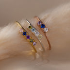 The Multiple Birthstone Curve Ring in Rose Gold features colorful gemstones on a delicate band—ideal as a birthstone ring or for creating a unique stacked look.