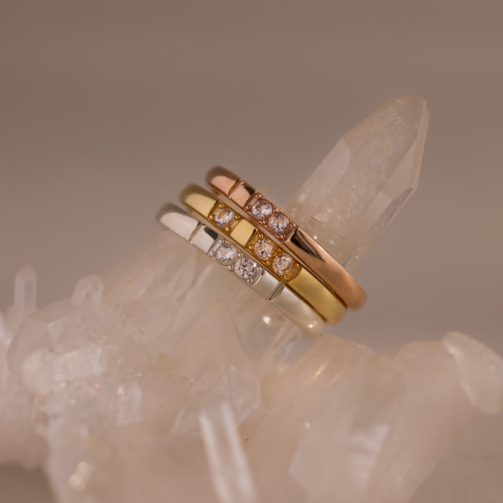The Diamond Morse Code Ring in Rose Gold features a symbolic diamond design, displayed on clear quartz—perfect for adding meaningful style to your jewelry collection.