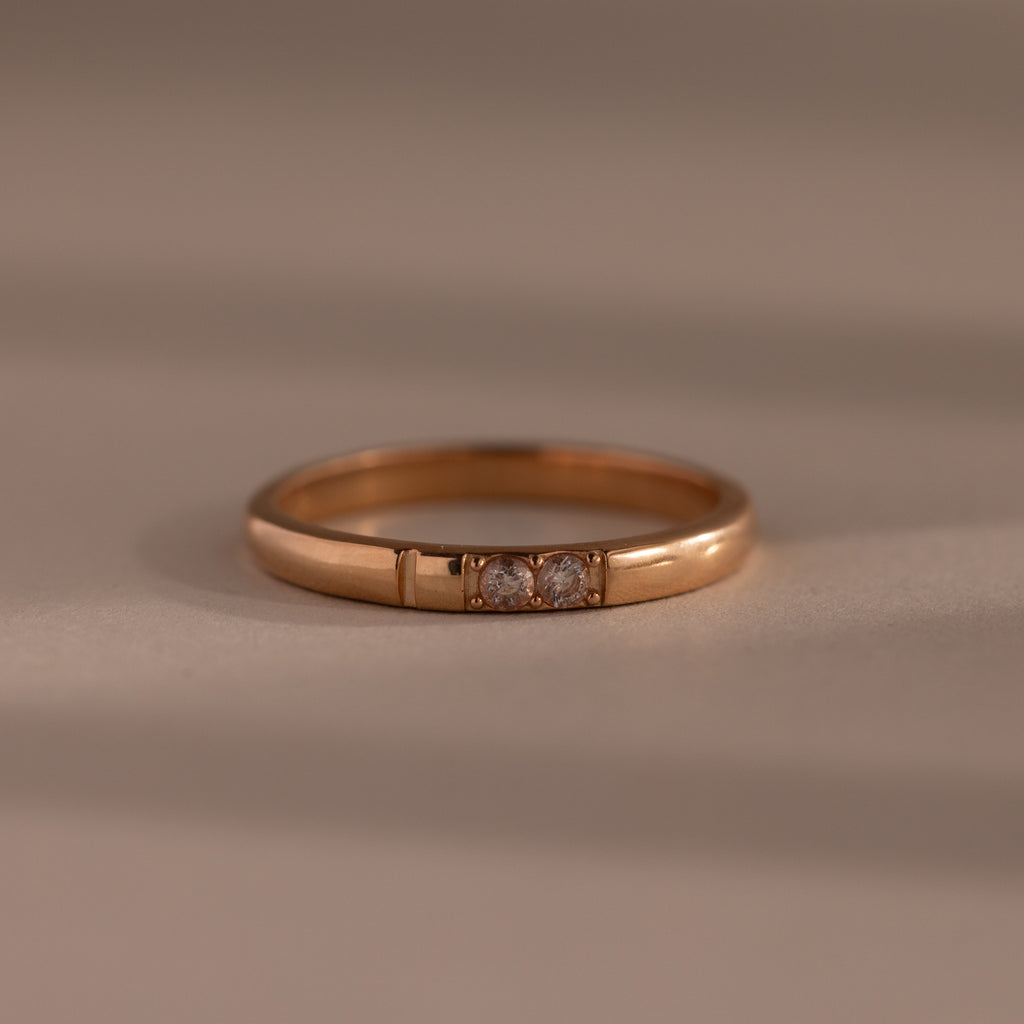 The Diamond Morse Code Ring in Rose Gold features three small center diamonds, creating an elegant and meaningful piece—perfect for those seeking a symbolic accessory.